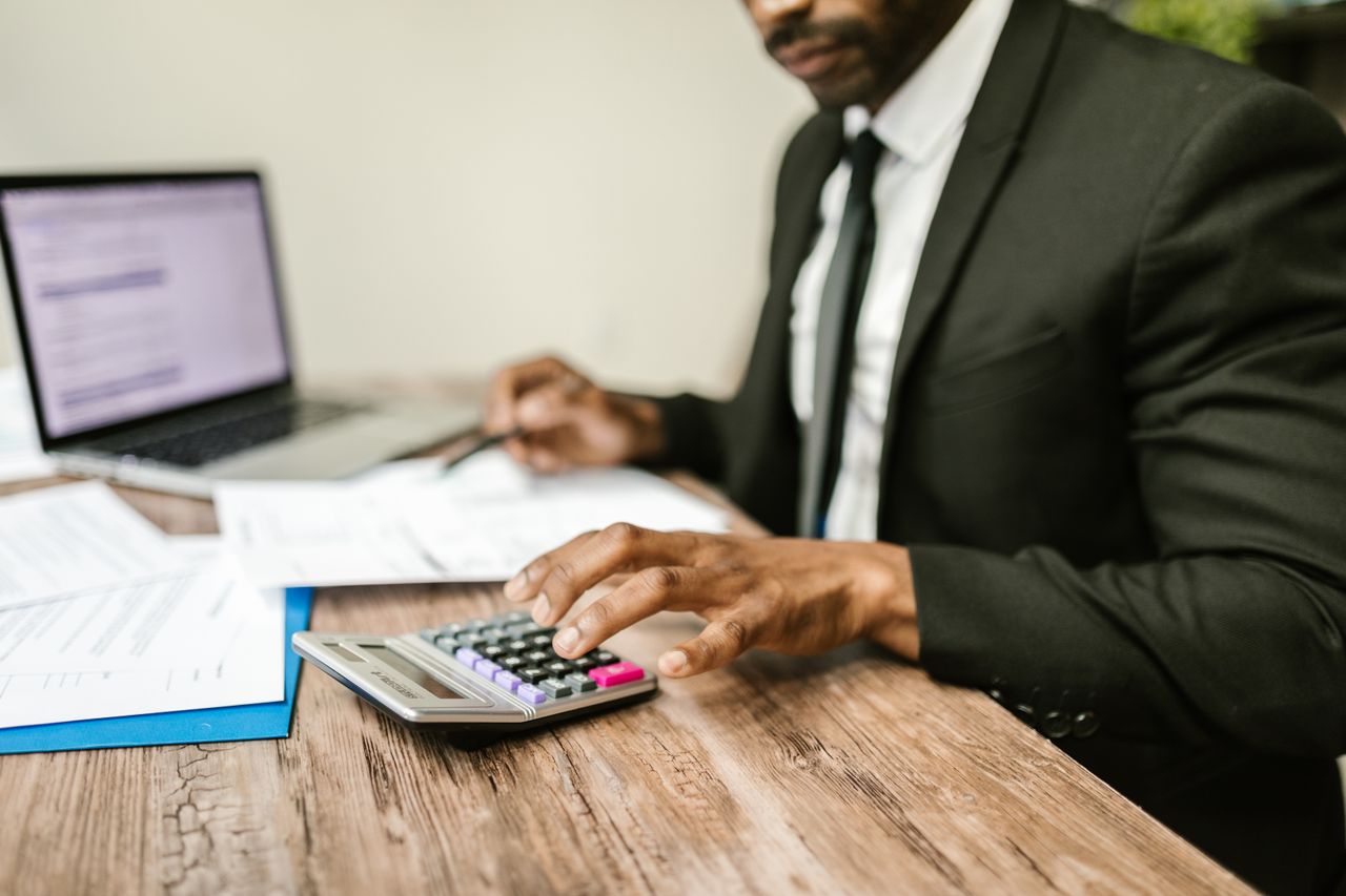Homeowner reviewing finances while considering debt review due to bond payment pressure and rising household costs